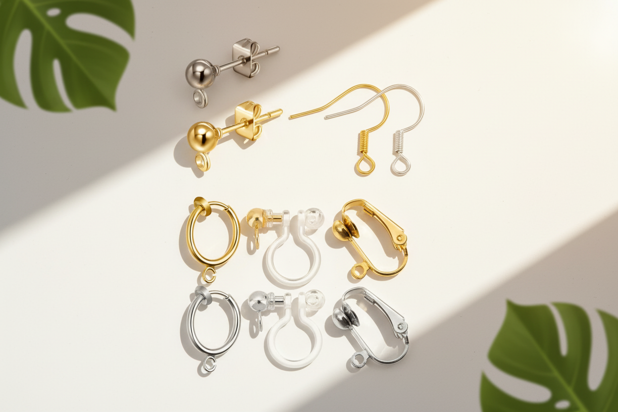 Collection of gold and silver earrings on a generated cream background with plant greenery in the forefront
